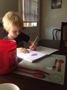 K writing in his journal